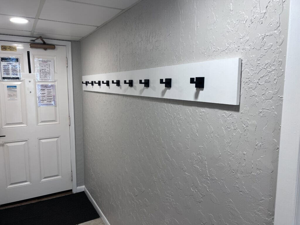 Coat hooks on a white wall at Edgewater Beach Resort Panama City Beach FL.